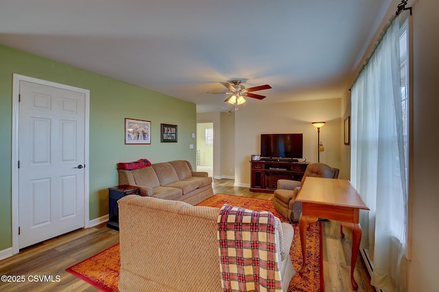 living room featuring hardwood / wood-style flooring and ceiling fan