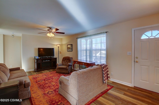 living room featuring ceiling fan and light hardwood / wood-style flooring