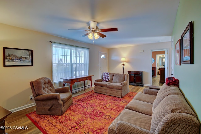 living room with hardwood / wood-style flooring, ceiling fan, and a baseboard heating unit