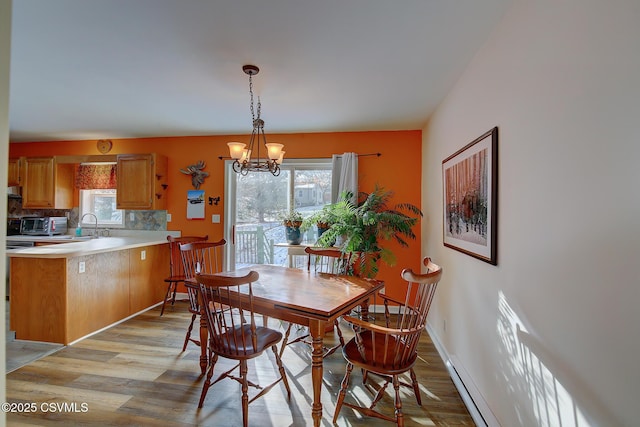 dining room featuring a chandelier and light hardwood / wood-style flooring