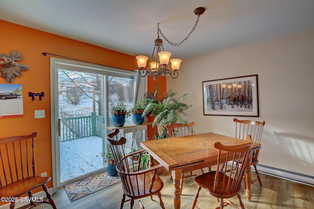 dining room with hardwood / wood-style flooring and an inviting chandelier