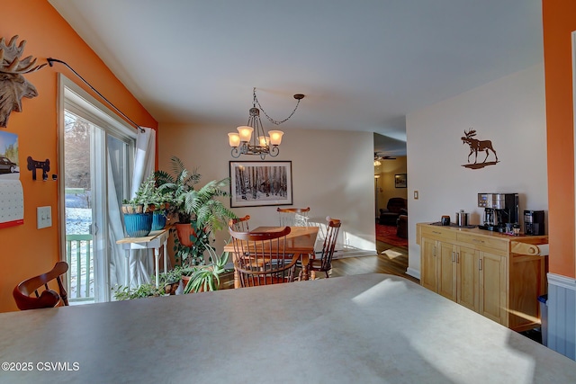 dining area with ceiling fan with notable chandelier