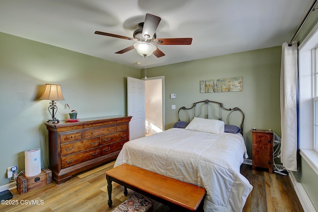 bedroom featuring hardwood / wood-style floors and ceiling fan