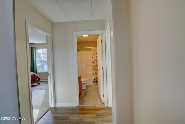 corridor with light hardwood / wood-style floors