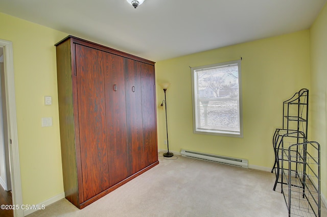 carpeted bedroom with a closet and a baseboard heating unit