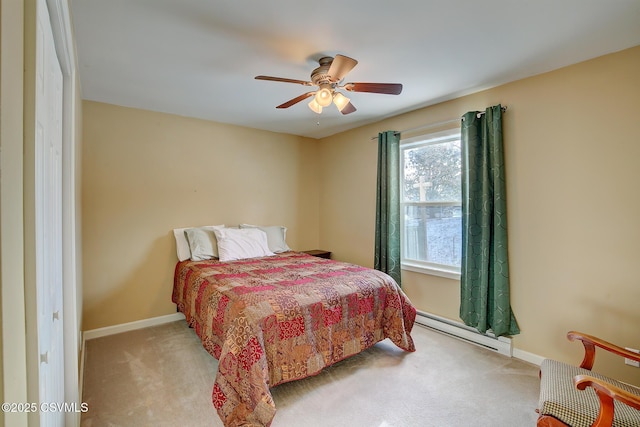 bedroom with ceiling fan, light carpet, and a baseboard heating unit