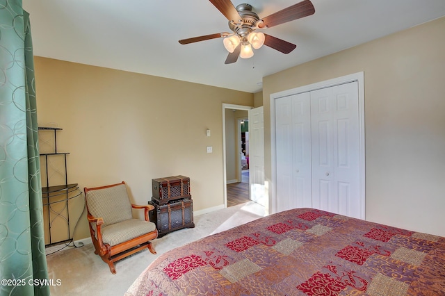 bedroom featuring ceiling fan, a closet, and light colored carpet