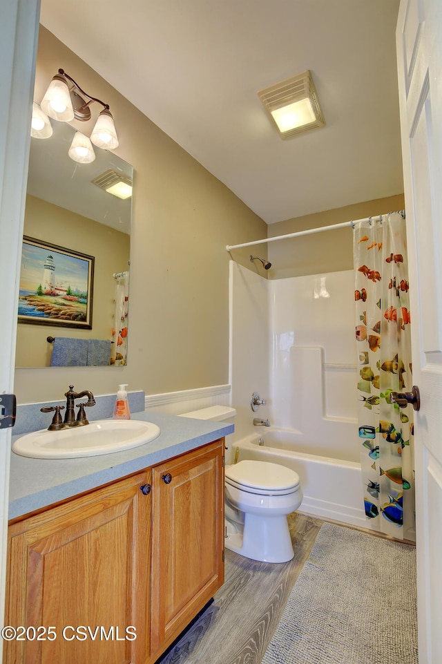 full bathroom with shower / bath combo with shower curtain, vanity, wood-type flooring, and toilet