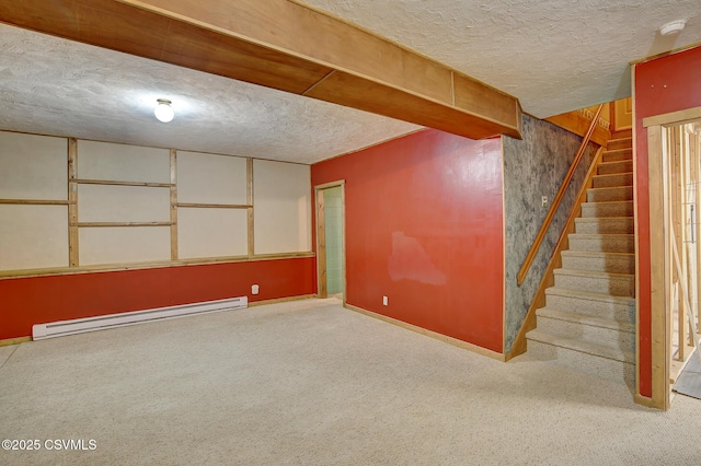 basement with carpet flooring, a textured ceiling, and a baseboard heating unit