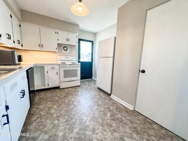 kitchen with white cabinetry, sink, and white appliances