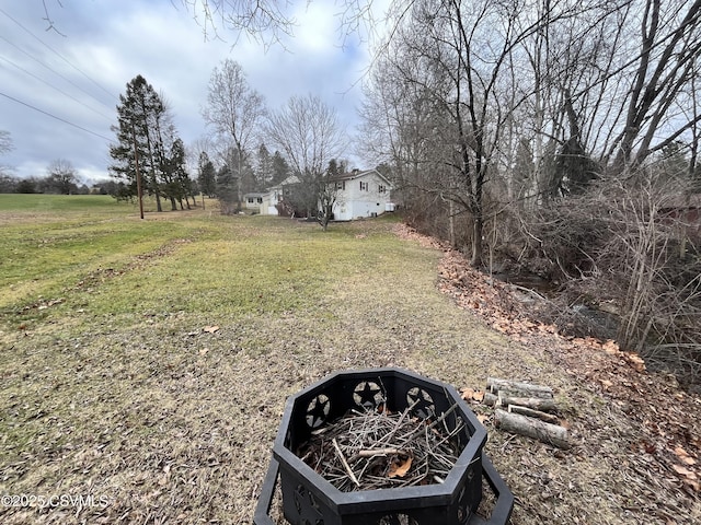 view of yard with an outdoor fire pit