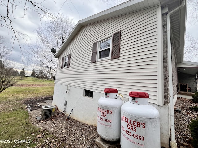 view of side of home with central AC unit