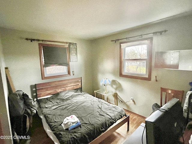 bedroom with wood-type flooring