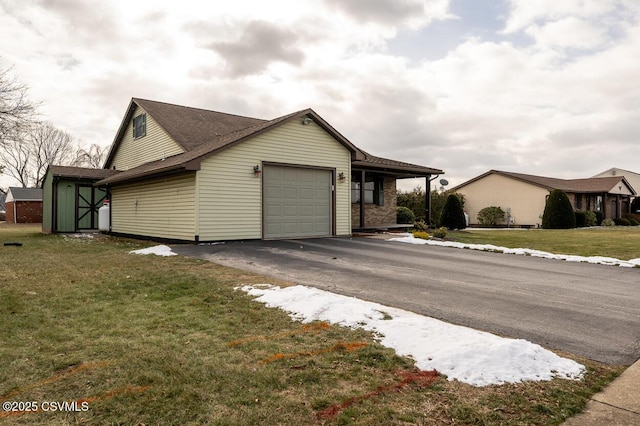 view of side of home featuring a yard and a garage