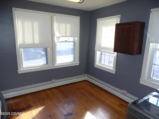 spare room with dark hardwood / wood-style floors and plenty of natural light