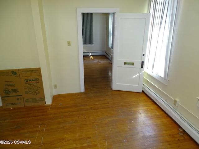 interior space with baseboard heating and hardwood / wood-style floors