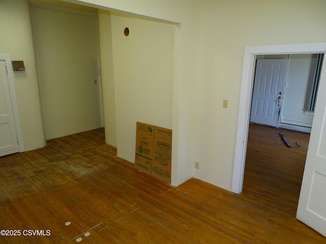 spare room featuring hardwood / wood-style floors and a baseboard radiator