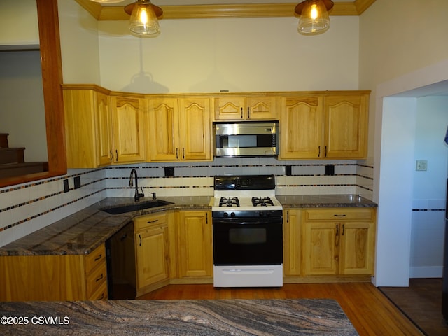 kitchen featuring sink, black dishwasher, gas range oven, dark hardwood / wood-style floors, and decorative backsplash