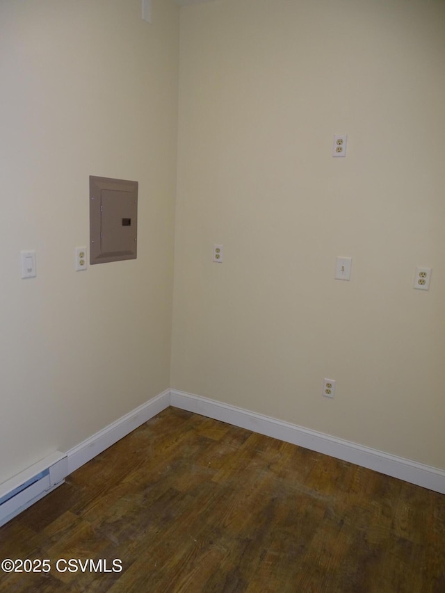 washroom featuring electric panel, dark wood-type flooring, and a baseboard heating unit