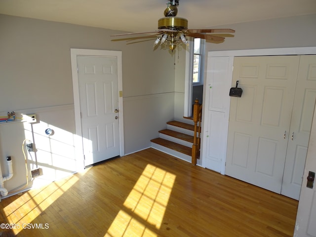 entrance foyer with ceiling fan and hardwood / wood-style flooring