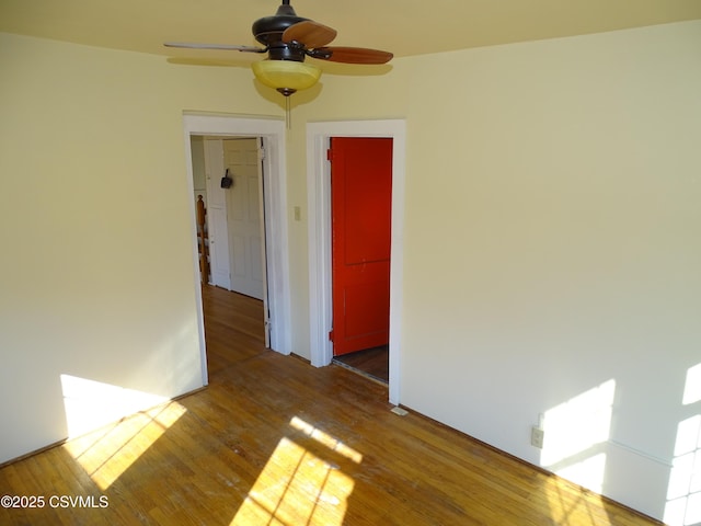 empty room with hardwood / wood-style flooring and ceiling fan