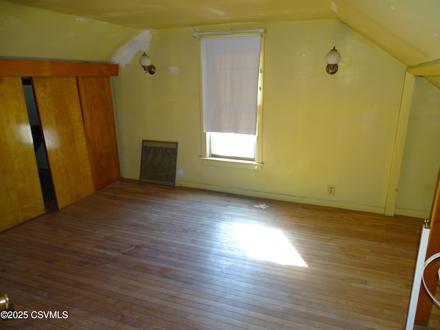 bonus room featuring light wood-type flooring and lofted ceiling