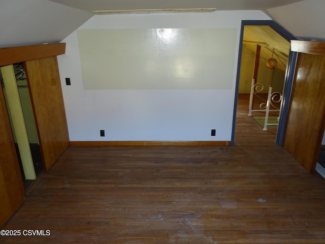 unfurnished room with dark hardwood / wood-style flooring and vaulted ceiling