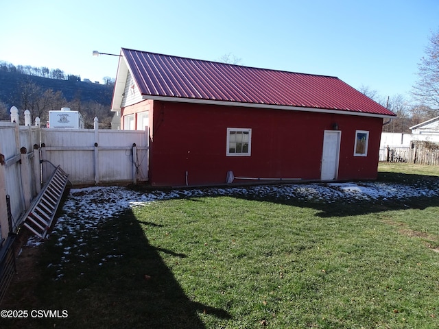 rear view of house featuring a yard