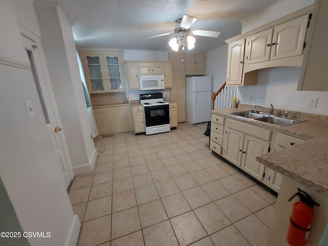 kitchen featuring white appliances, cream cabinets, sink, ceiling fan, and light tile patterned floors