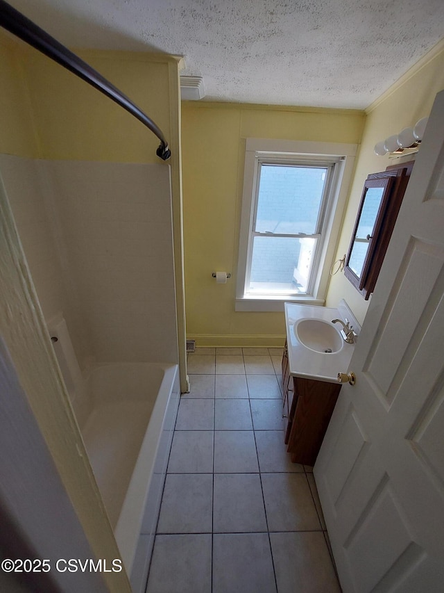 bathroom with vanity, tile patterned floors, crown molding, a textured ceiling, and walk in shower