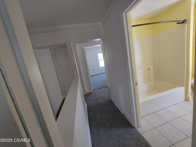 bathroom featuring tile patterned floors, ornamental molding, tub / shower combination, and toilet