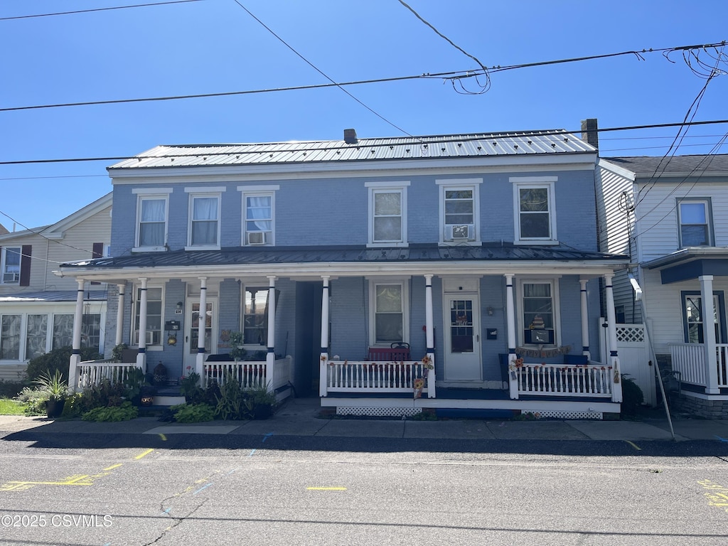 townhome / multi-family property with a porch