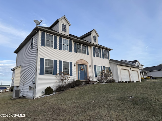 colonial inspired home with central AC unit, a garage, and a front lawn