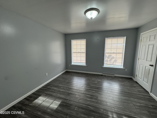 spare room featuring dark wood-type flooring