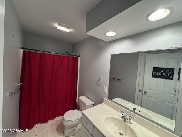 bathroom featuring walk in shower, vanity, and toilet