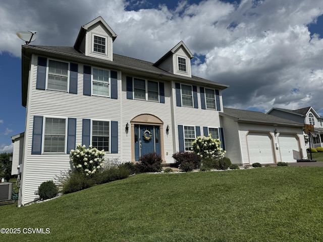 colonial home featuring a front yard, a garage, and central AC unit