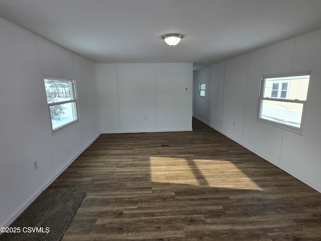 spare room featuring dark wood-type flooring