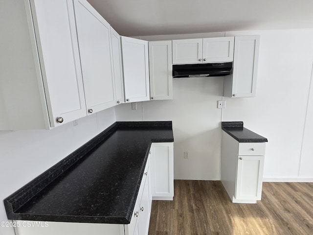 kitchen featuring dark hardwood / wood-style floors and white cabinets