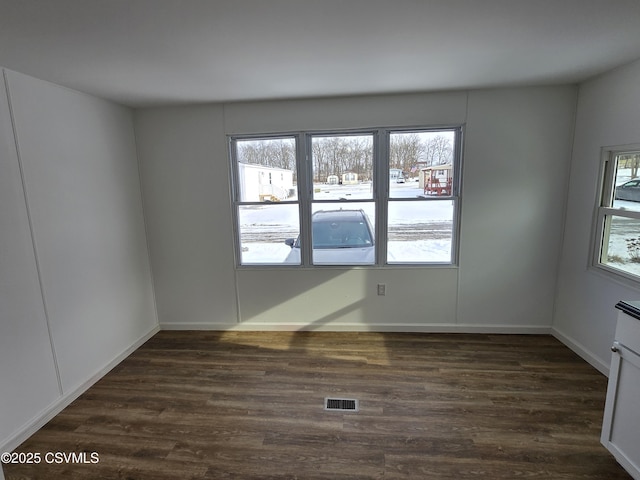 unfurnished room featuring dark wood-type flooring