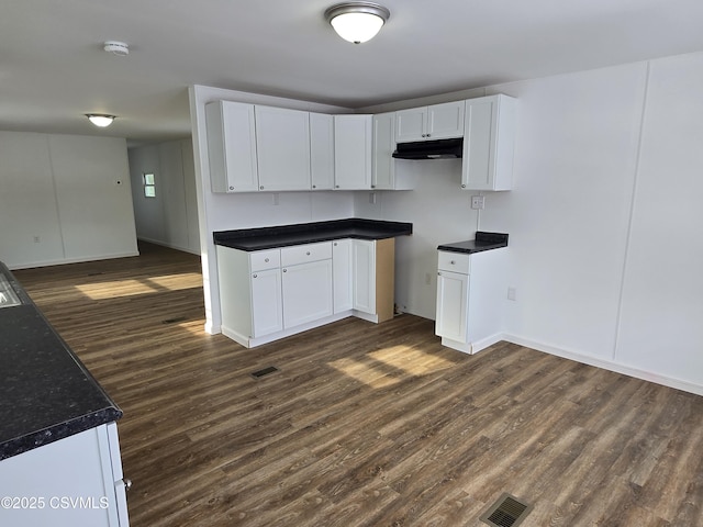 kitchen with white cabinetry and dark hardwood / wood-style flooring