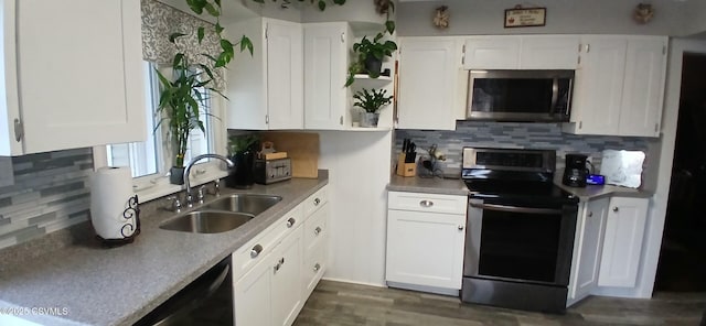 kitchen featuring white cabinets, sink, decorative backsplash, appliances with stainless steel finishes, and dark hardwood / wood-style flooring