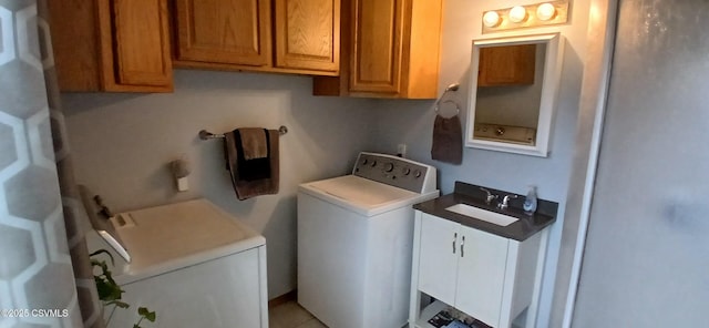 laundry room with cabinets and washer / dryer