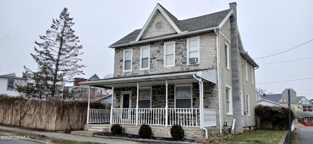 view of front of house with cooling unit and covered porch