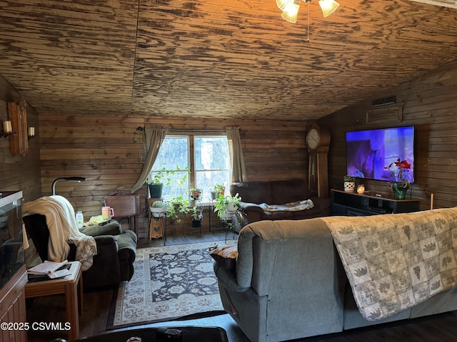 living room featuring lofted ceiling, wooden walls, and wooden ceiling