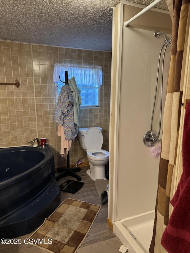 bathroom featuring tile walls, wood-type flooring, a textured ceiling, toilet, and walk in shower