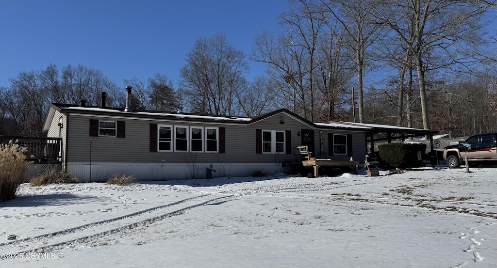 view of snow covered rear of property