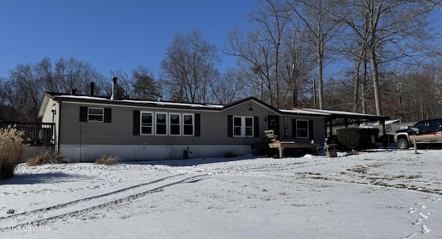 view of snow covered rear of property