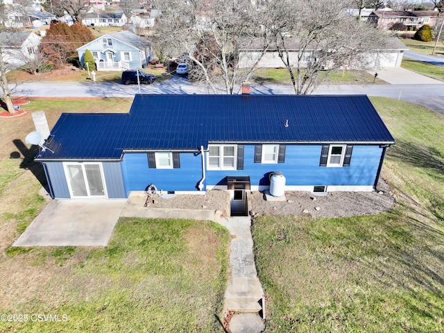 rear view of property featuring a lawn