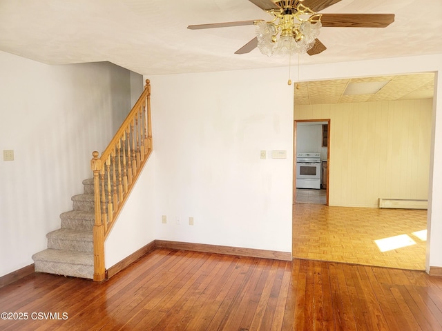 unfurnished room with ceiling fan, wood-type flooring, and a baseboard heating unit