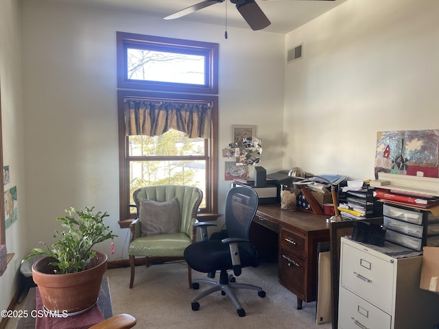 carpeted home office featuring ceiling fan and plenty of natural light